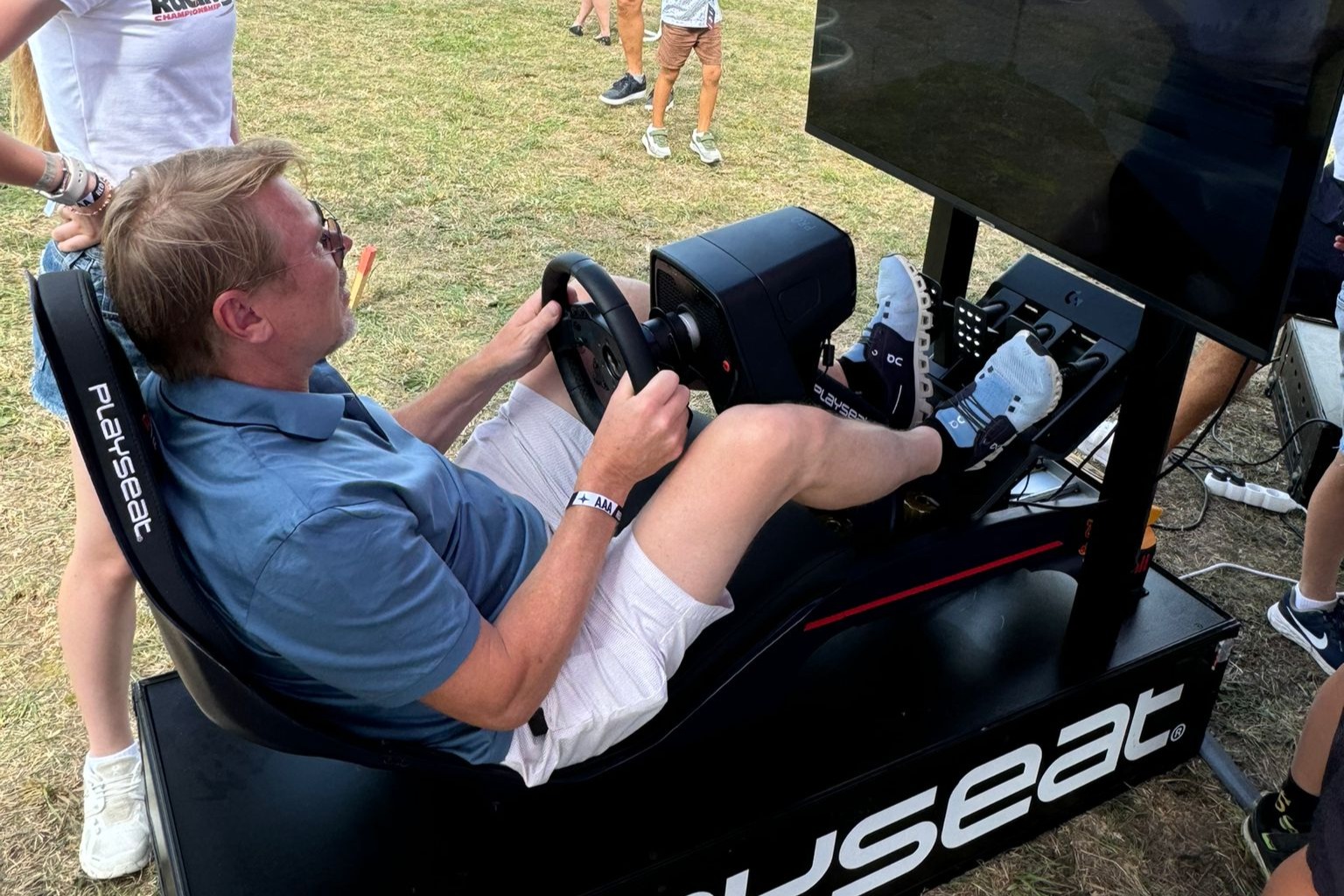 Mika Häkkinen plays on a racing simulator